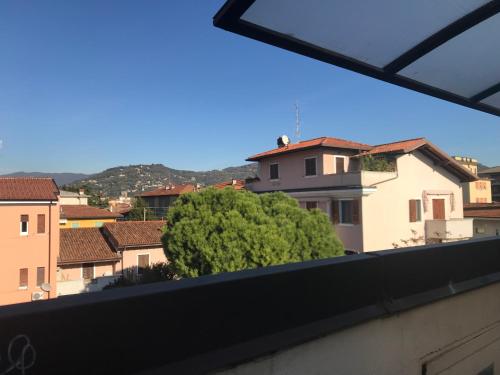 a view of a tree from a balcony at Mansardine Metropolitane in Brescia