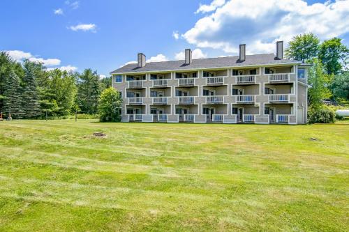 a large building with a large field in front of it at Grey Fox Inn in Stowe
