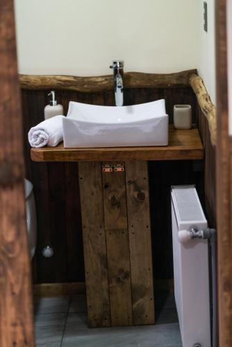a bathroom with a sink on a wooden vanity at Estancia Dos Elianas in Torres del Paine
