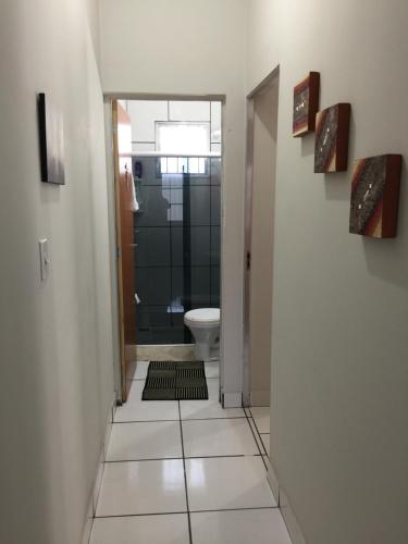 a hallway with a bathroom with a shower and a toilet at Apto Floramar in Belo Horizonte