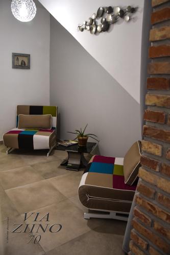 a living room with a couch and a chair at Via Ziino 70 in Oliveri