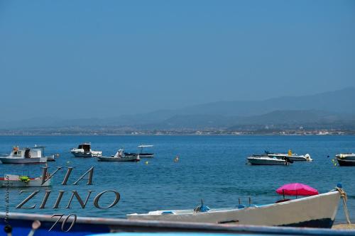 a group of boats in a large body of water at Via Ziino 70 in Oliveri