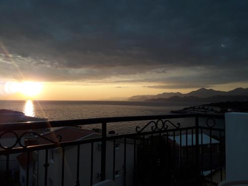 a view of the ocean from a balcony at sunset at Apartments Tina in Utjeha