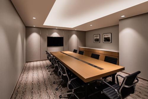 a conference room with a long table and chairs at Ramada by Wyndham Seoul Sindorim in Seoul