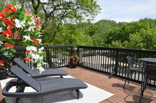 una terraza con 2 sillas, una mesa y flores en Auberge de La Fontaine, en Montreal