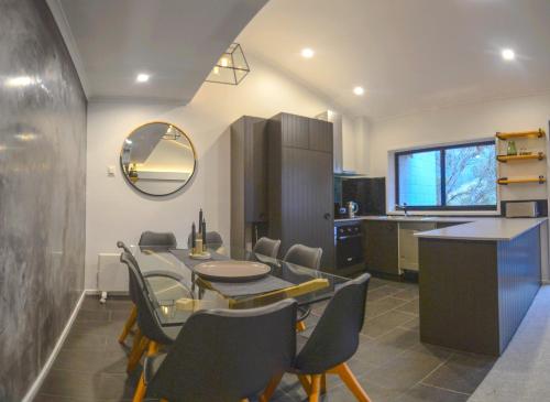 a kitchen and dining room with a table and chairs at Mowamba F2 in Thredbo