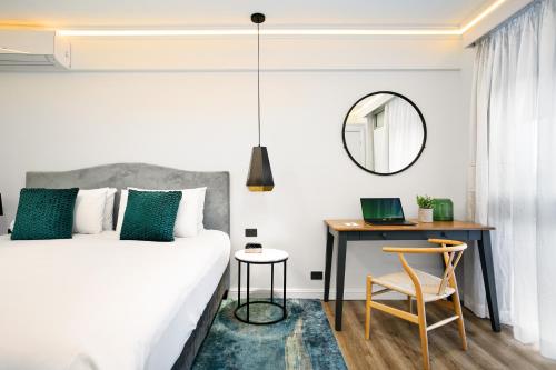 a bedroom with a bed and a desk and a mirror at Best Western Sanctuary Inn in Tamworth