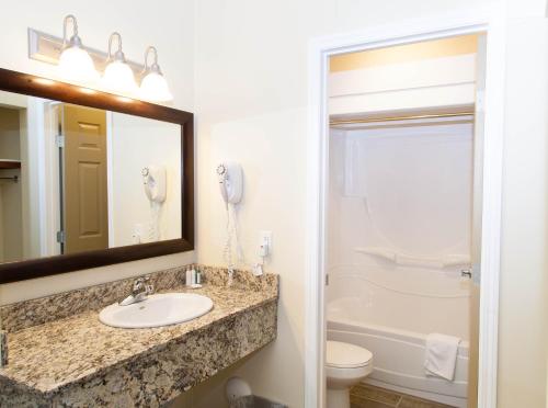 a bathroom with a sink and a toilet and a mirror at Hinton Lodge in Hinton