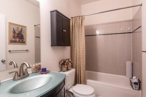 a bathroom with a sink and a toilet and a shower at Cozy home nearby most attractions Seattle center in Seattle