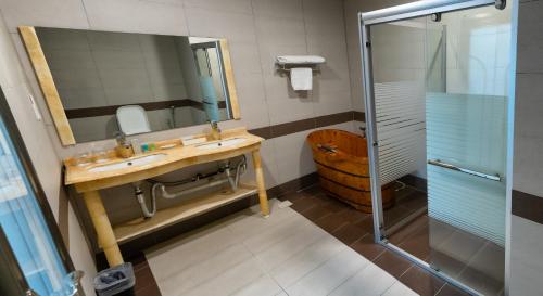 a bathroom with a sink and a shower at Seri Simanggang Hotel in Simanggang