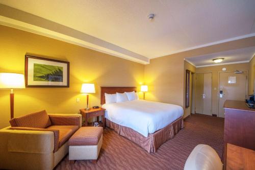 a hotel room with a bed and a couch at The Water Tower Inn - BW Premier Collection in Sault Ste. Marie