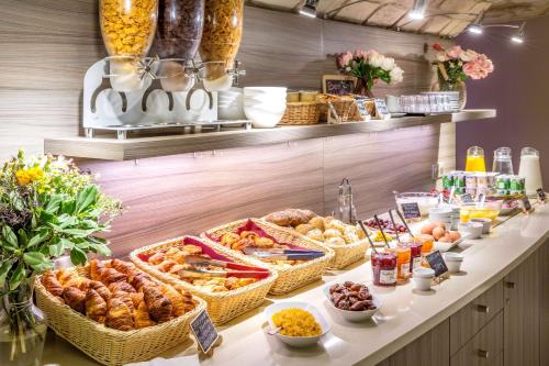 a buffet with many baskets of food on a table at Sure Hotel by Best Western Paris Gare du Nord in Paris