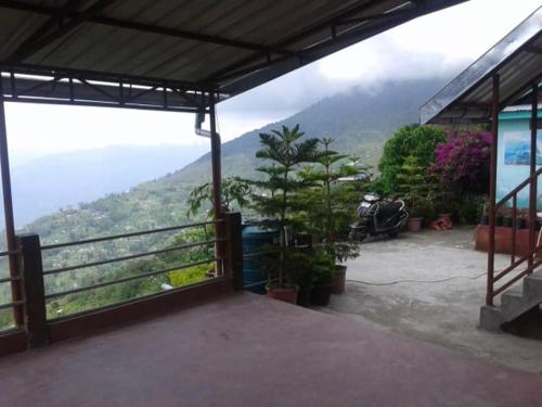 a view of a balcony with a view of a mountain at Vamoose Khaling in Pedong