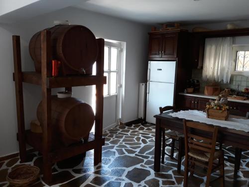 een keuken met een tafel en een witte koelkast bij Peggy's house in Monastiraki
