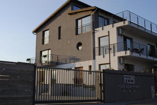 a building with a fence in front of it at H49 Apartman Wellness & Spa - Adults only in Sovata