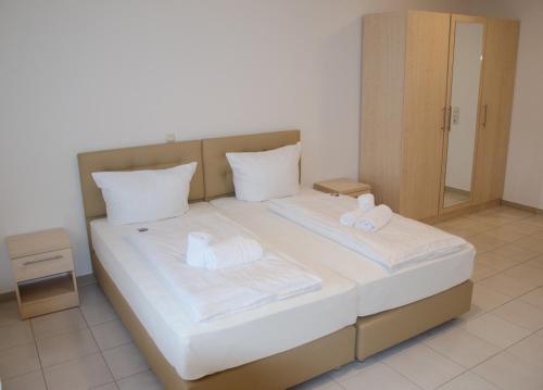 a bedroom with a bed with two towels on it at Kraichtaler Hof in Kraichtal