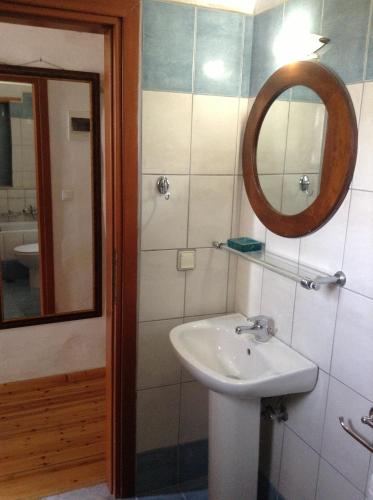 a bathroom with a sink and a mirror at Porto Paradiso in Chrissi Akti