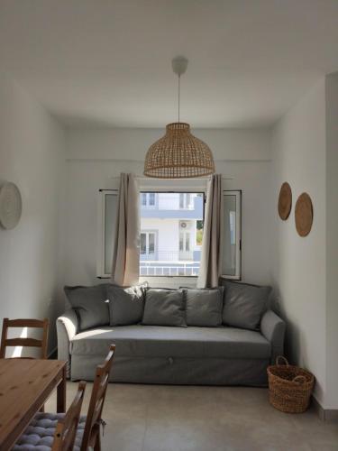a living room with a couch and a window at Ellie Apartments Stalida in Stalida