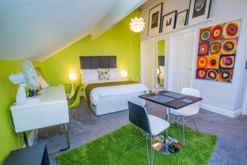 a bedroom with a bed and a table and chairs at James' Place at Dowlais in Merthyr Tydfil