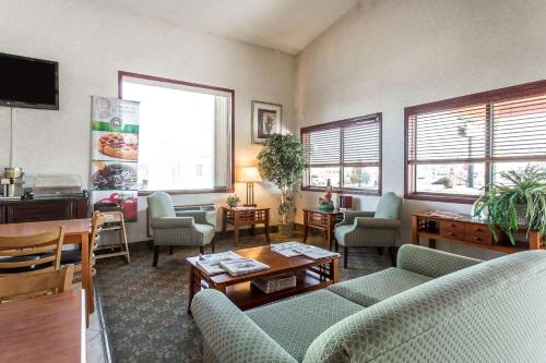 a living room with couches and chairs and windows at Quality Inn Delta Gateway to Rocky Mountains in Delta