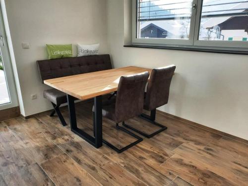 a wooden table and chairs in a room at Casa Vierthaler in Scheffau am Wilden Kaiser