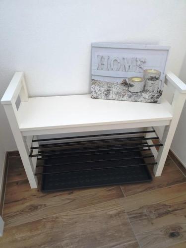 a white bench sitting on top of a wooden floor at Casa Vierthaler in Scheffau am Wilden Kaiser