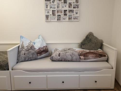 a bench with pillows on it in a room at Casa Vierthaler in Scheffau am Wilden Kaiser