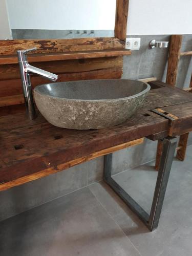 a stone sink sitting on top of a wooden table at Casa Vierthaler in Scheffau am Wilden Kaiser