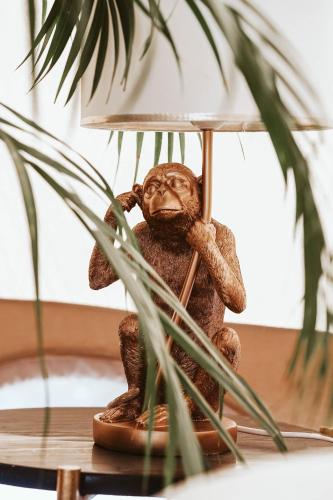 a monkey sitting on a table under a lamp at Dreamsea Mediterranean Camp in Benitachell