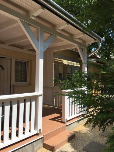 a wooden deck with awning on a house at Szem-s Vendégház in Balatonszemes