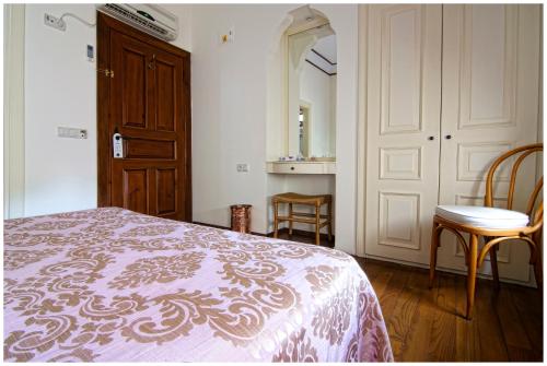 a bedroom with a bed and a table and a mirror at Minyon Hotel in Antalya