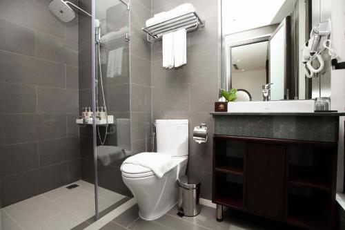 a bathroom with a toilet and a sink and a mirror at Hanoi Fiesta Hotel & Spa in Hanoi