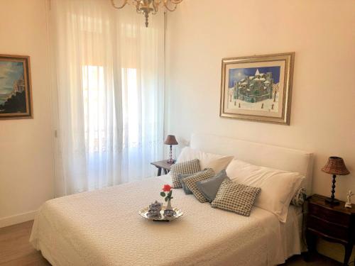 a bedroom with a white bed with a plate on it at Atmosfera d'Arte - Private parking in Orvieto