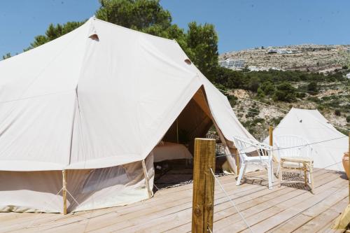 a large white tent on a wooden deck at Dreamsea Mediterranean Camp in Benitachell