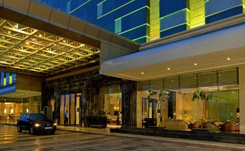 a car parked in front of a building at Radisson Blu Jaipur in Jaipur
