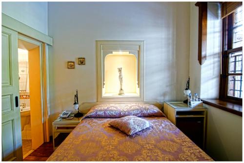 a bedroom with a bed and a desk and a window at Minyon Hotel in Antalya