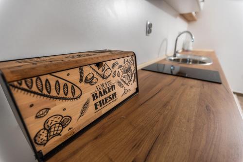 a wooden cutting board sitting on top of a kitchen counter at Premium Inn in Gevgelija