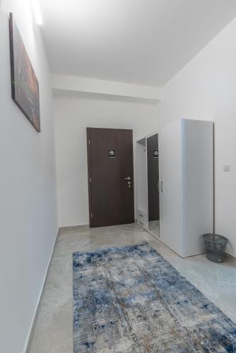 an empty room with a blue rug on the floor at Premium Inn in Gevgelija