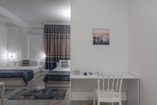 a bedroom with a bed and a desk and a table at Premium Inn in Gevgelija