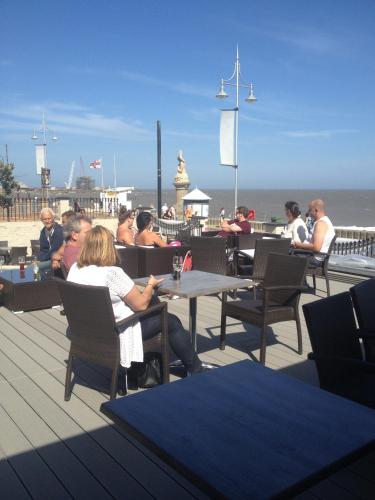 a group of people sitting at tables on a deck at Best Western Hotel Hatfield in Lowestoft