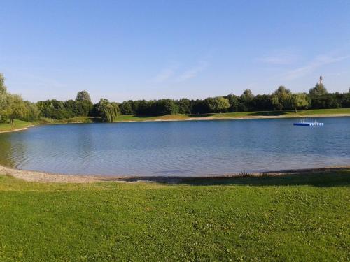 a large lake with a boat in the middle at Landhotel Grätz in Emmering