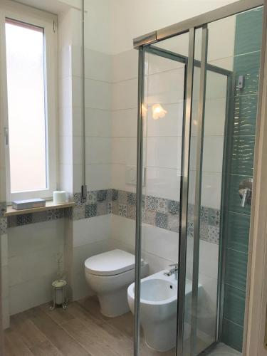 a bathroom with a toilet and a sink at Atmosfera d'Arte - Private parking in Orvieto