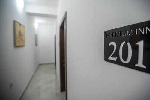 a sign on the wall of a room with a hallway at Premium Inn in Gevgelija