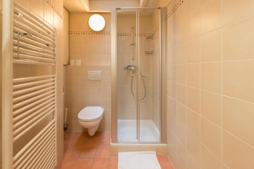 a bathroom with a shower and a toilet and a sink at City Flats by Lybeer Hotel Group in Bruges