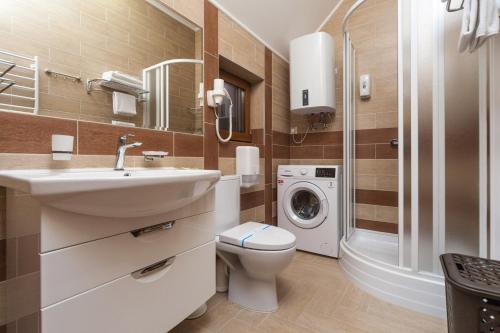a bathroom with a sink and a washing machine at Kompleks Otdykha Elki-Palki in Odesa