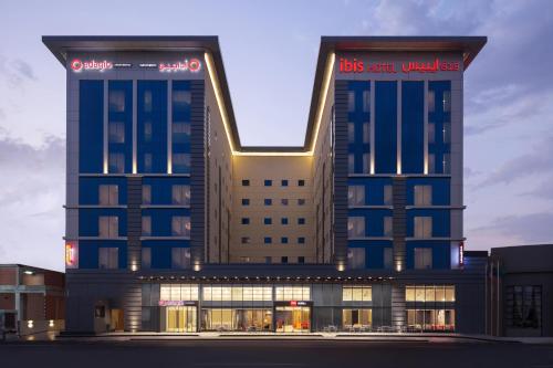 a building with two towers with lights on it at Ibis Jeddah Malik Road in Jeddah