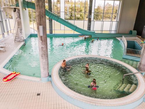 a group of people swimming in a swimming pool at Lübker Golf Resort in Nimtofte