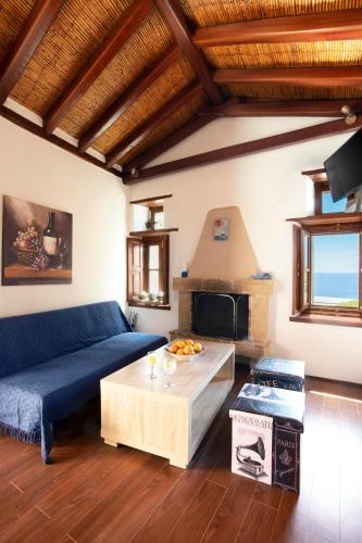 a living room with a couch and a fireplace at Ypatia Cozy Castle Suite Apartment with Loft in Monemvasia