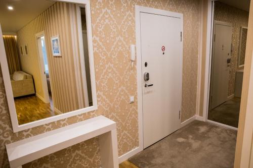 a bathroom with a sink and a mirror at Antakalnis 5 stars apartment in Vilnius
