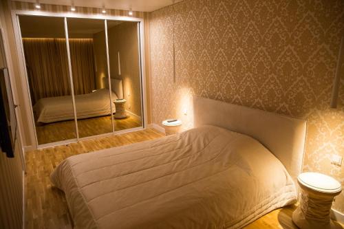 a bedroom with a bed and a large mirror at Antakalnis 5 stars apartment in Vilnius